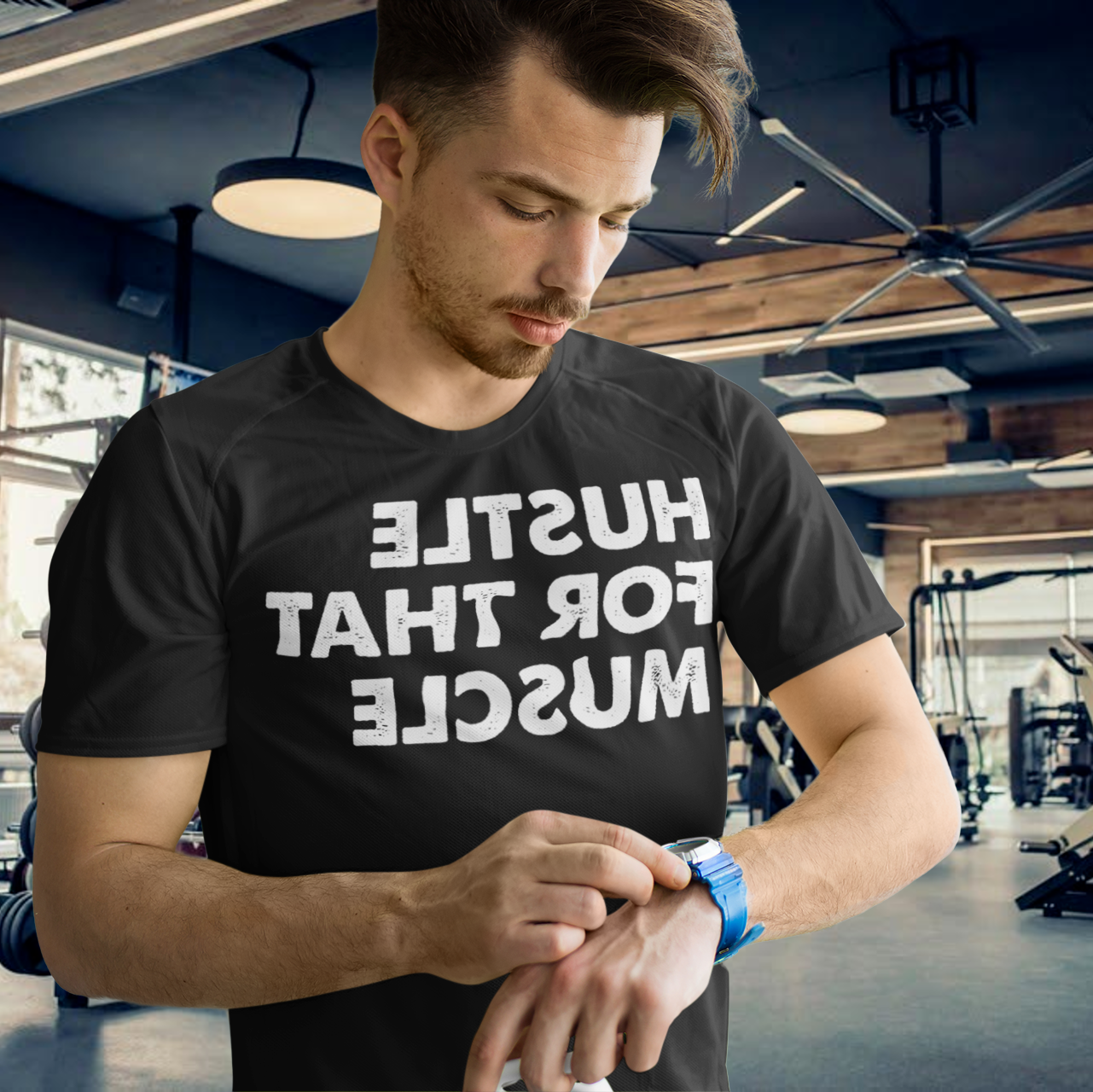 Man at a gym checking his time - Hustle for the muscle