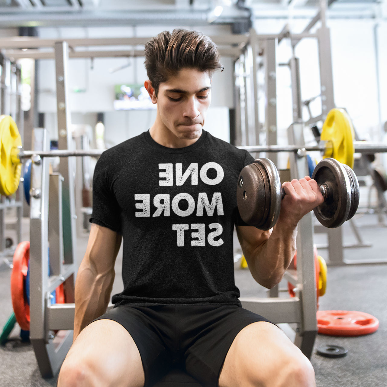 Man doing bicep curls in the gym - One More Set