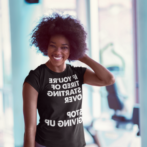 Smiling woman at the gym - If you're tired of starting over Stop Giving Up