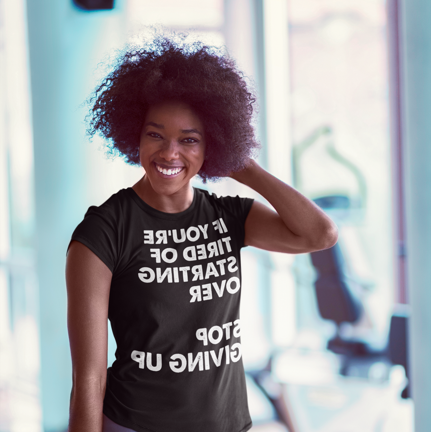 Smiling woman at the gym - If you're tired of starting over Stop Giving Up