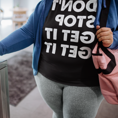 Woman using her phone to enter the gym - Don't stop get it get it