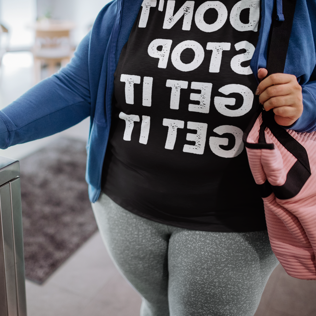 Woman using her phone to enter the gym - Don't stop get it get it