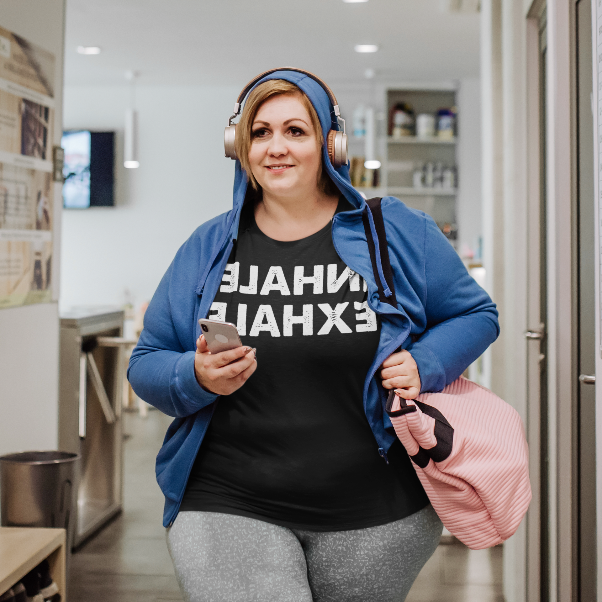 Woman walking with her headphones on - Inhale Exhale
