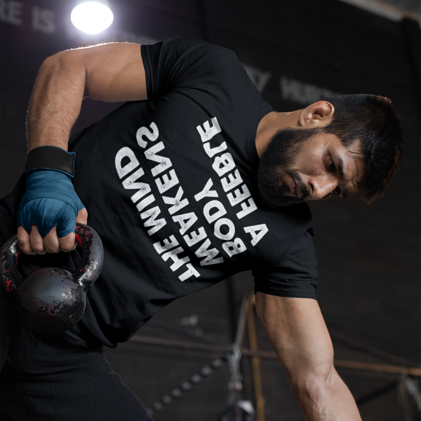 Muscular man training at the gym - A Feeble body weakens the mind